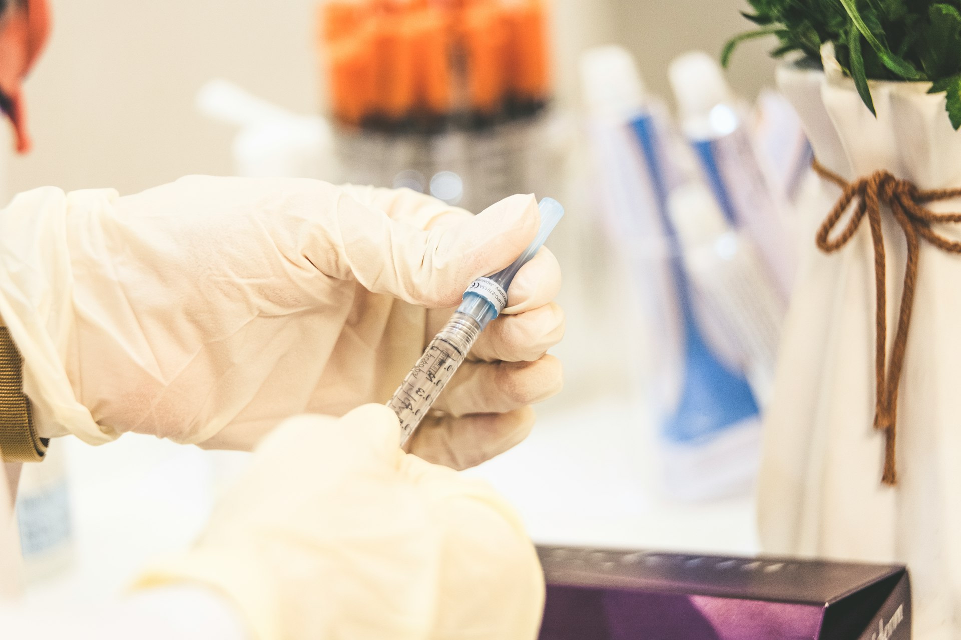 hands of a clinician holding a syringe
